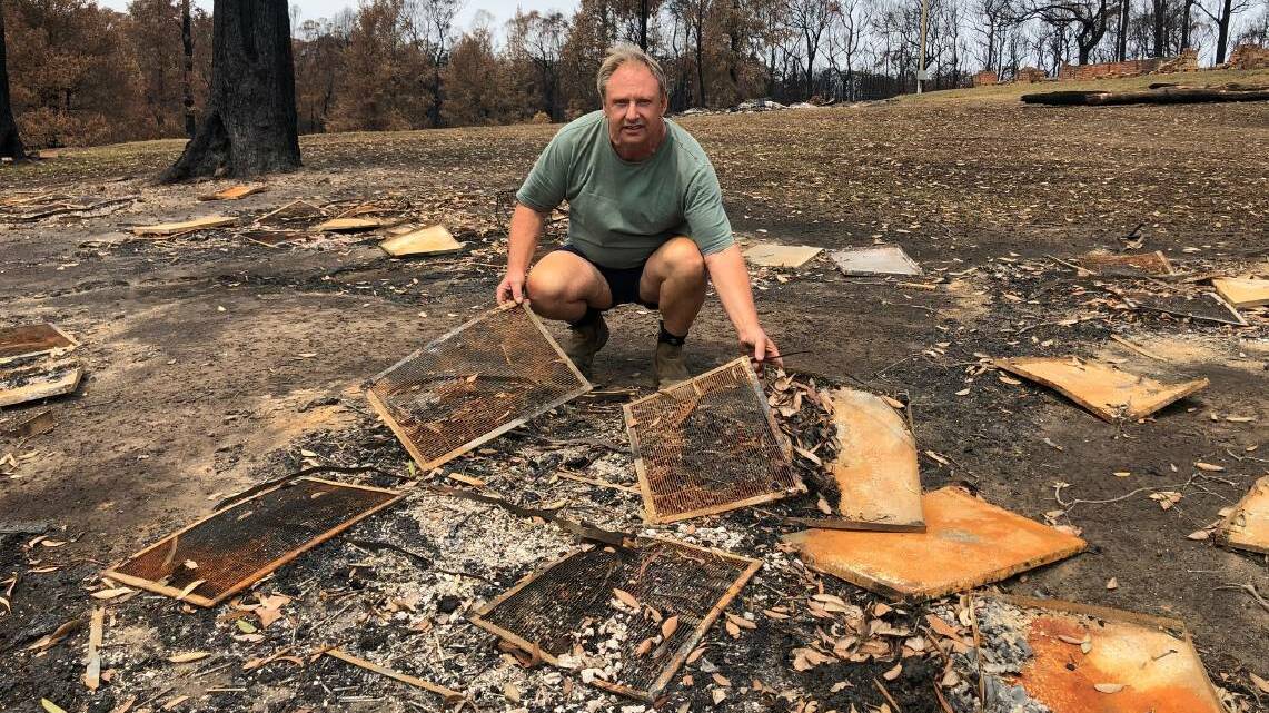LAST YEAR: Vince Ingold with some of the hives, along with $10,000 worth of honey and millions of bees, lost to the fire.
