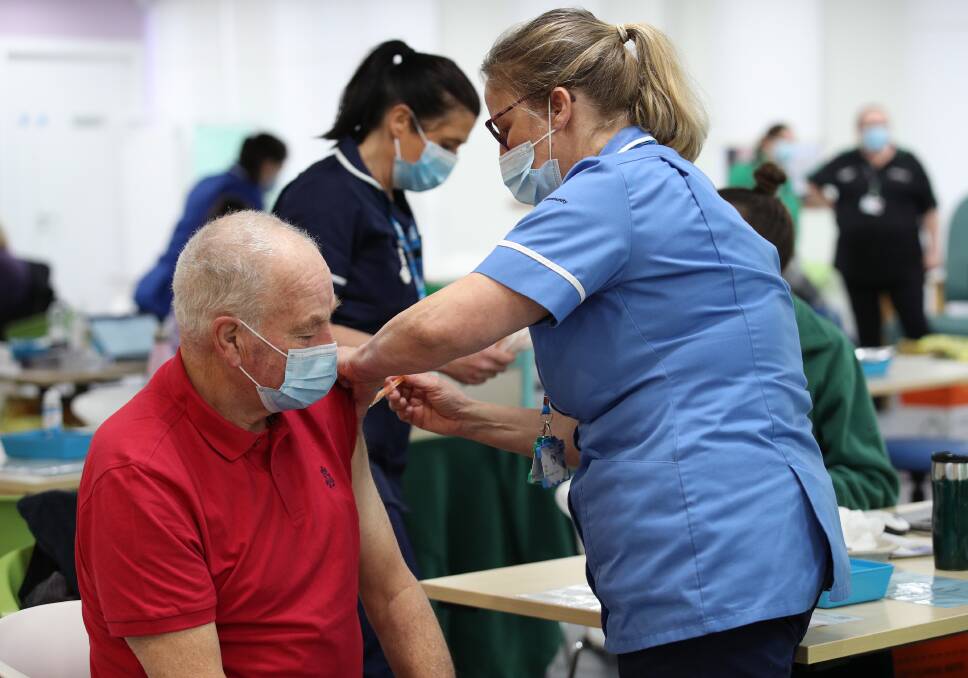 Immunisation Nurse Silja Mai, gives Ron Mees, 69, a dose of the Oxford/Astra Zeneca COVID-19 vaccine, during a mass vaccination in the UK on Tuesday. Picture: Getty Images