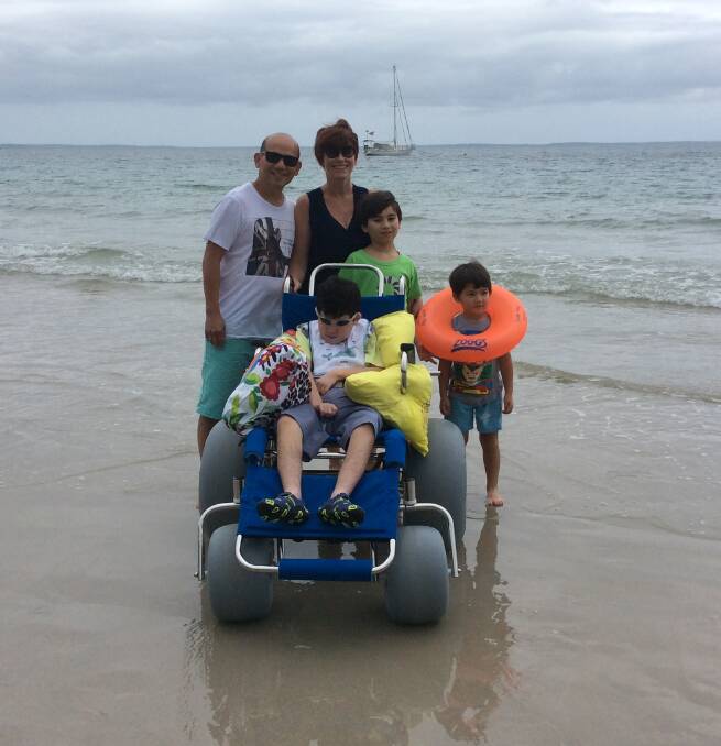 The Pham family - Annette, Hao, Liam, Ryan and Adam - enjoy a day at the beach.