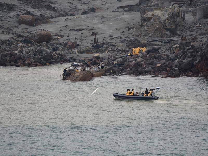 Police and navy divers are back in the waters around White Island looking for two more bodies.
