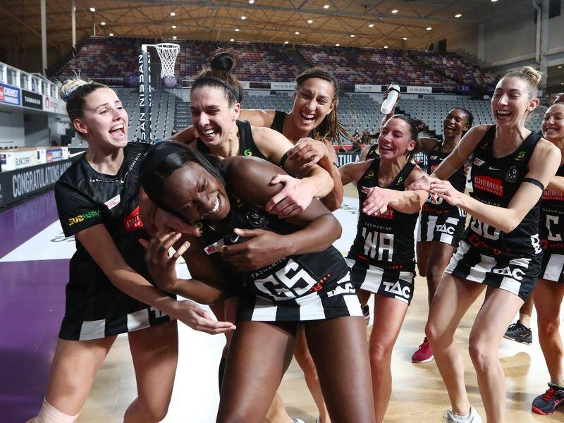 Magpie Shimona Nelson is mobbed by her team after scoring 69 goals in the 75-68 win over the Swifts.