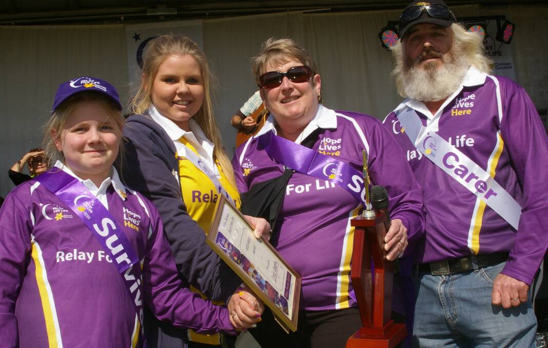 HONOUR: Cindy Wheatley, who was presented with the Heidi Brook Memorial Award at the 2014 Relay for Life, will be remembered at this year’s relay after recently losing her battle with cancer. Cindy was pictured with husband Shorty and Heidi’s daughters Lilly-Rose and Molly-Kate McKinnon.