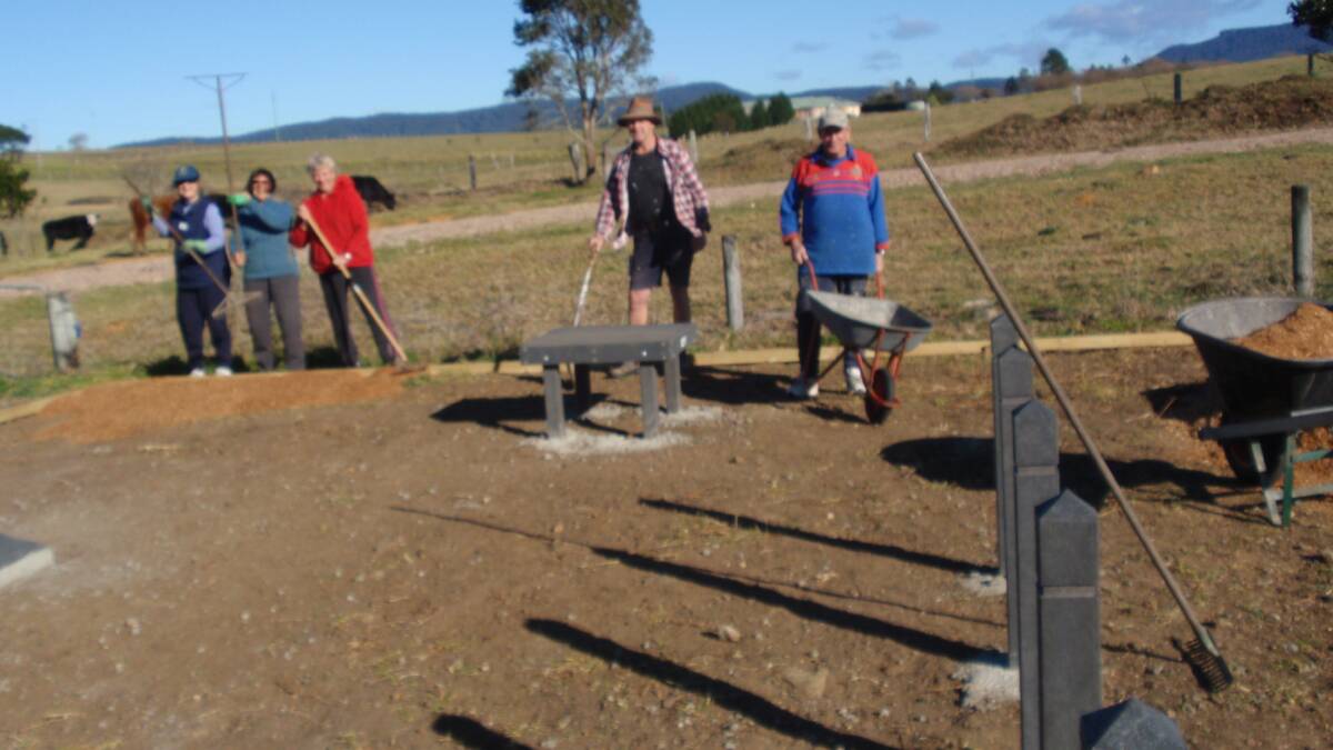 HARD WORKERS: Milton-Ulladulla Dog Training Club hard-working volunteers, instructors and committee members Janet Smith, Rosie Milton,Jenny Patch, Mark Wilden and Warwick Taylor help lay the mulch for the new puppy playground at Milton Showground. 