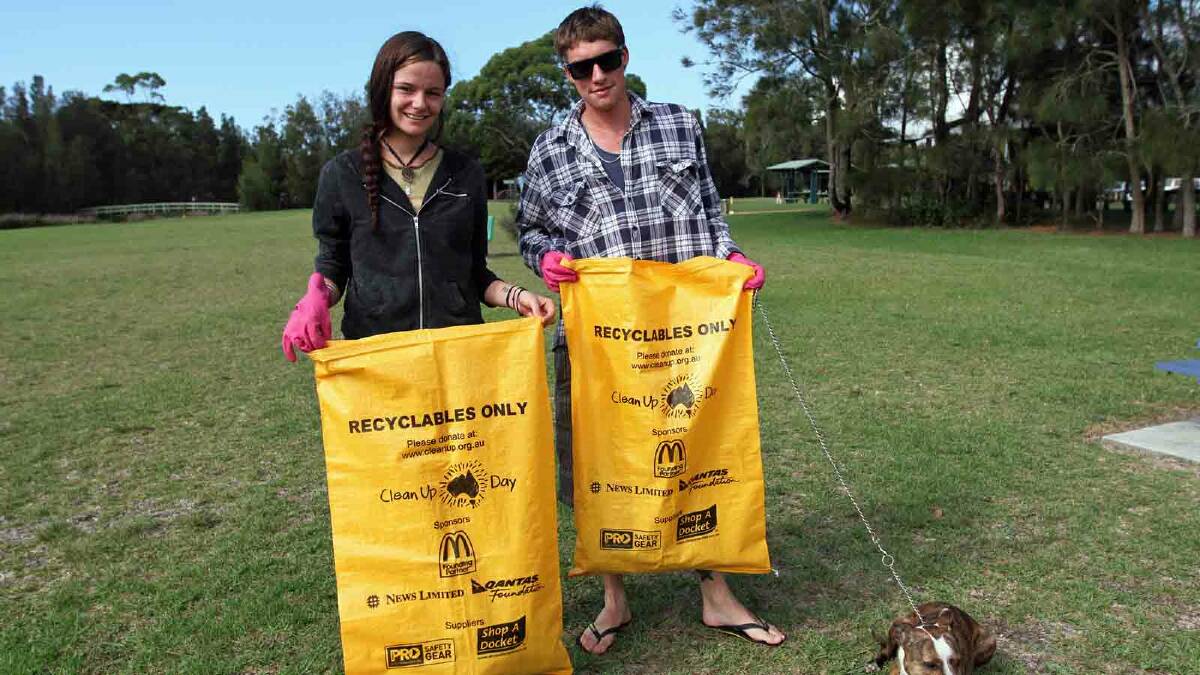 HELPING HANDS: Tegan Rossiter and Jesse Blewitt from Cooma took time out from their holiday to help Clean Up Australia Day at Burrill Lake.