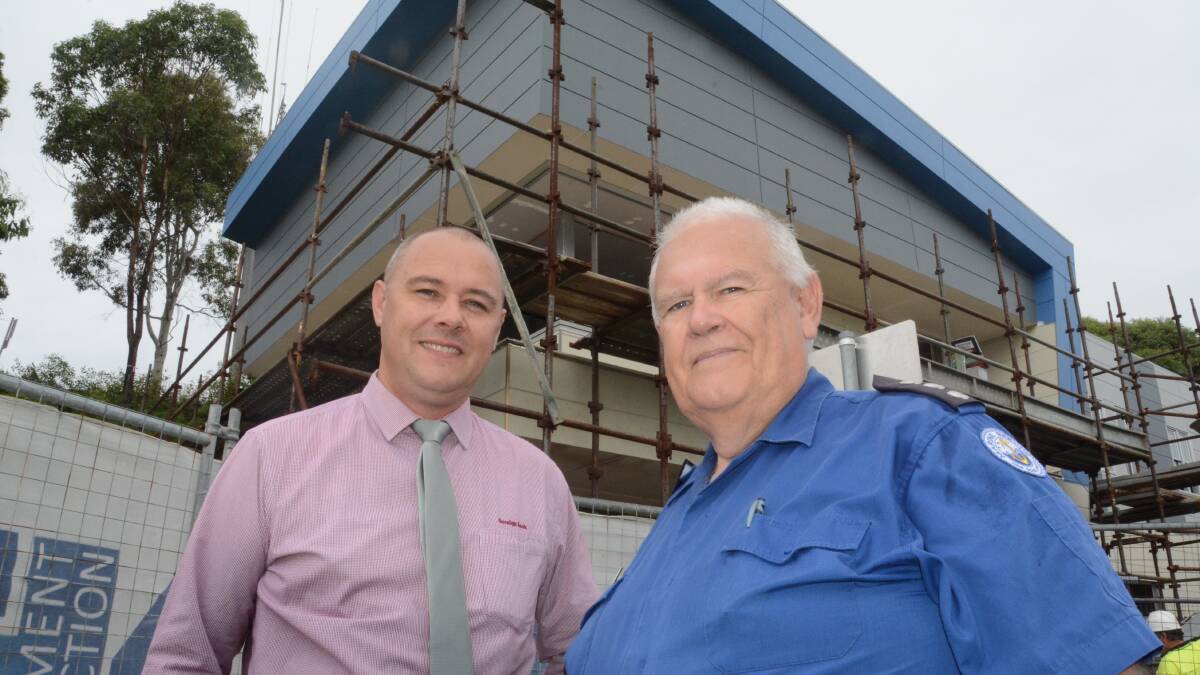 NEARLY THERE: Ulladulla Bendigo Bank manager Leigh Felton and Marine Rescue commander Ken Lambert in front of the new base, expected to open after Easter. 