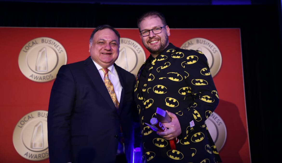 On track: Precedent Productions managing director Steve Loe with winner Peter Laybutt at the 2019 Illawarra & South Coast Local Business Awards. Picture: Greg Ellis. 