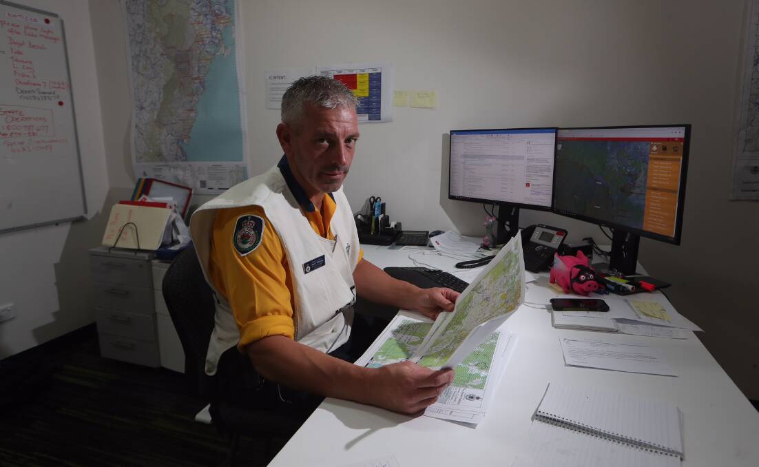 Currowan Fire incident controller Superintendent Mark Williams seated at his desk in the Shoalhaven Emergency Management Centre.