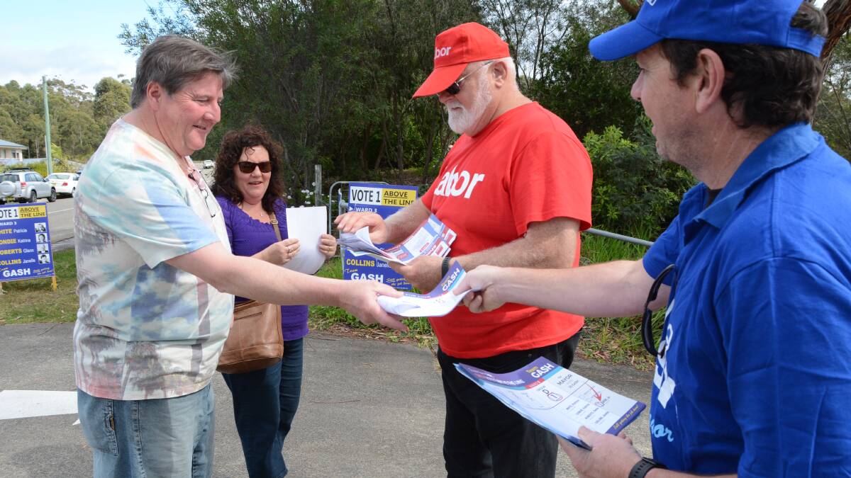 Volunteers handing out how-to-vote cards at a polling booth during the 2016 Shoalhaven City Council election.