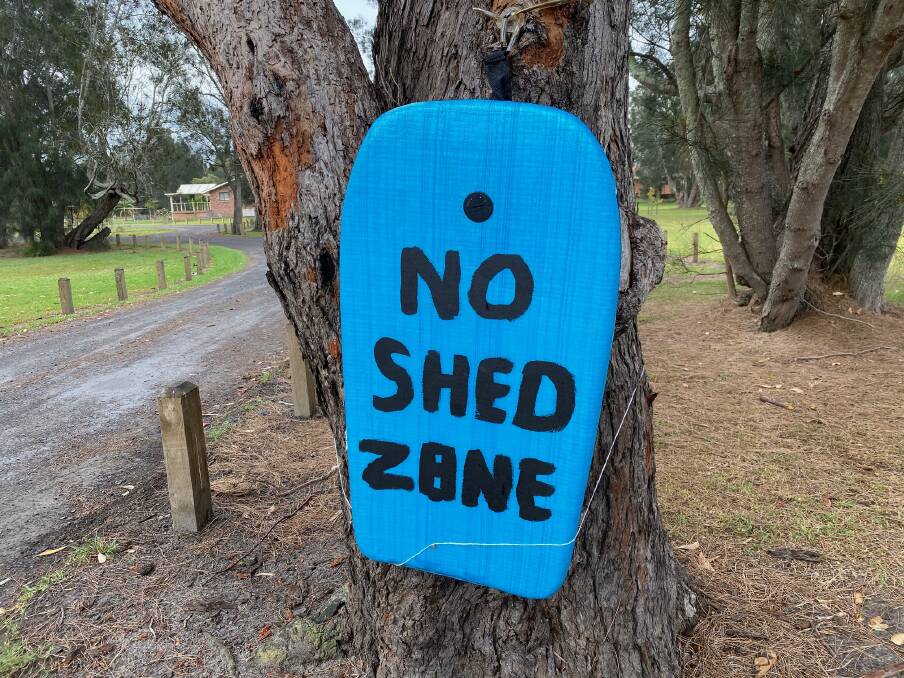 Several signs against the boat shed had appeared around Barker Reserve. 