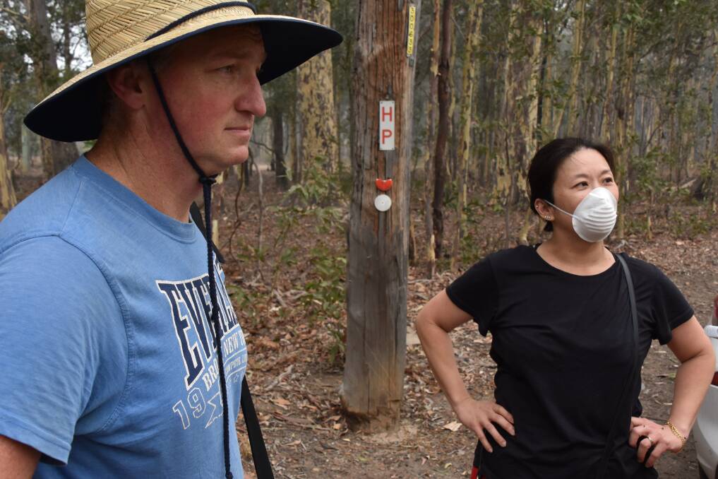 Nowra Hill residents Greg and Lucy Sweet along Albatross Road walking 2km to visit their property.