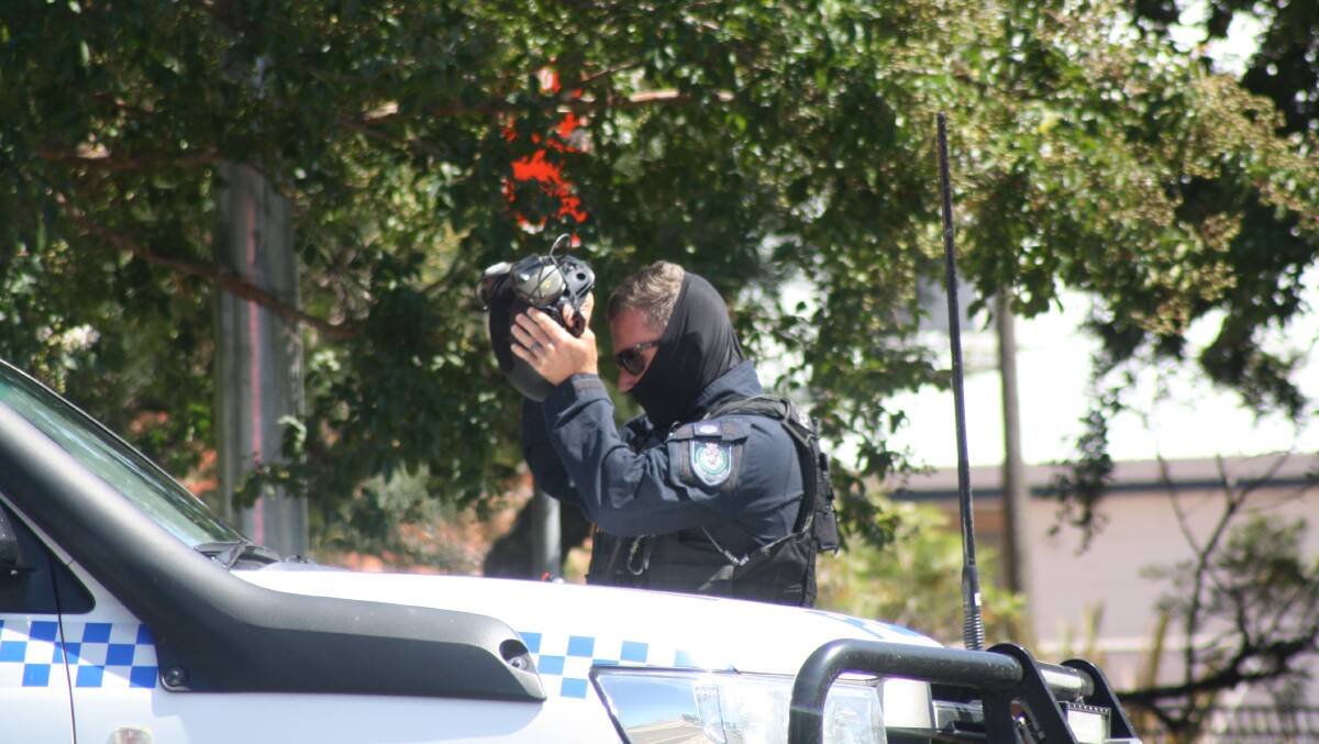Police and tactical response officers during a standoff with a man allegedly armed with a knife in Kinghorne Street, Nowra on Thursday, February 1. Picture by Glenn Ellard