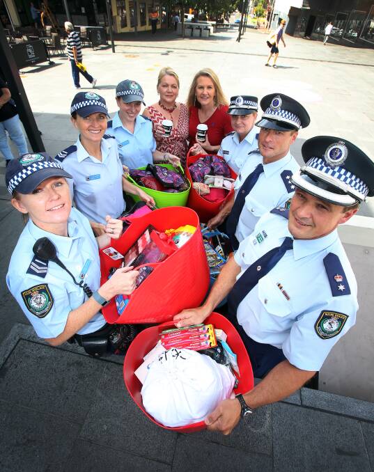 Assistant Commissioner Joe Cassar (bottom right), pictured in 2015 presenting hampers to the Supported Accommodation and Homeless Services Illawarra, has long been a police officer in the Illawarra. Picture by Robert Peet