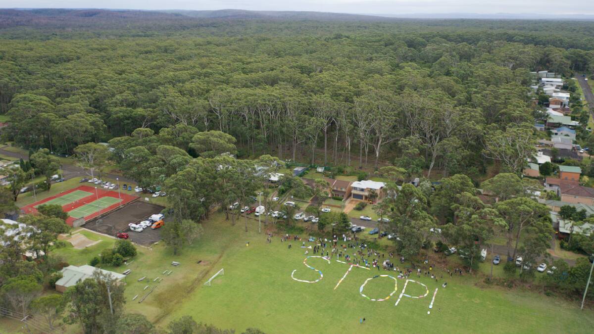 CLEAR MESSAGE: Manyana residents spell out their call for a halt to the development of a parcel of forest that escaped the bushfire, which they say is important for the survival of displaced wildlife.