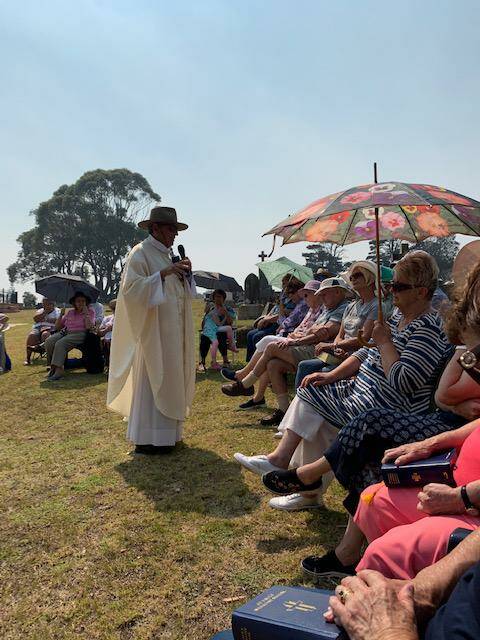  Fr Michael Dyer celebrates mass in the cemetery.