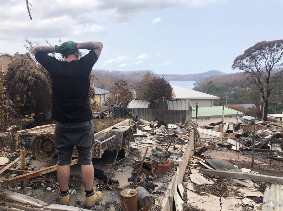 Ash views the remains of his house. Image supplied