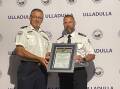 Marine Rescue Ulladulla Unit Commander John Samulski [left] receives a 50th anniversary framed certificate from Marine Rescue NSW Commissioner Alex Barrell.
