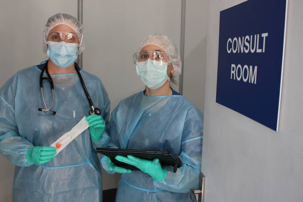Paulla Heany (left) is assisted by Liz Grist in Ulladullas pop-up Covid-19 testing clinic. 