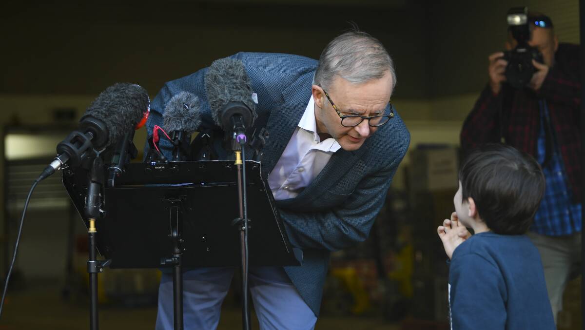 Anthony Albanese chats to a child who gatecrashed one his campaign press conferences. Picture: AAP