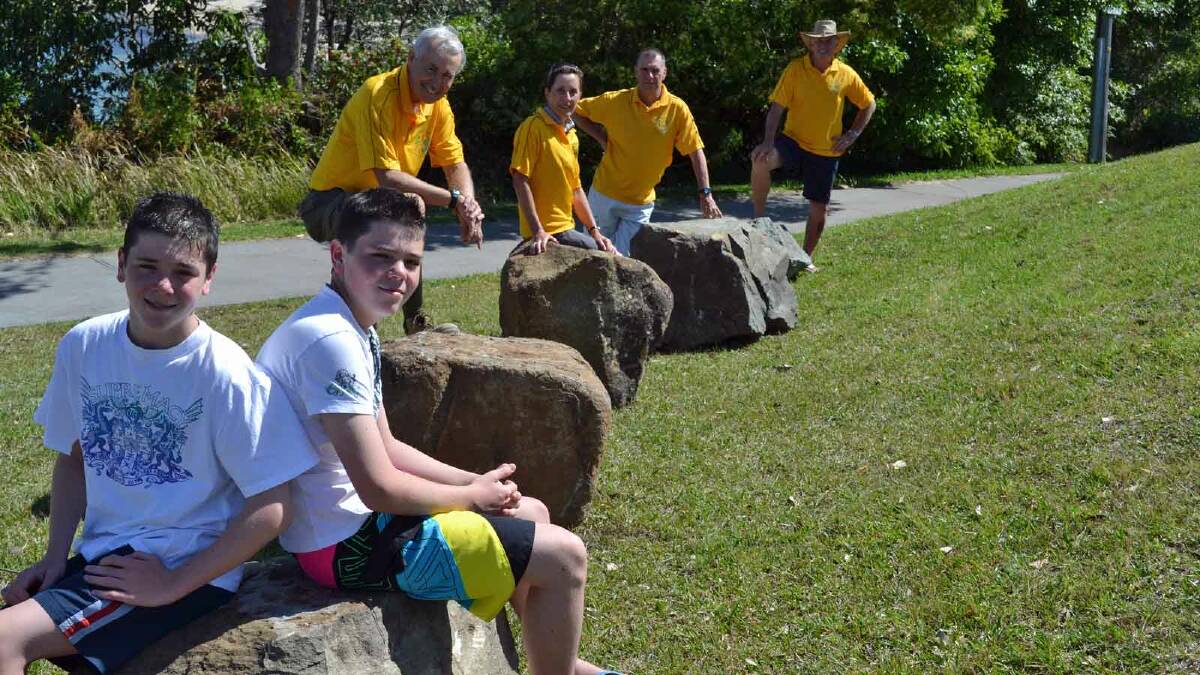 ROCK ON: Following the delivery of the first load of boulders last week, youngsters Ben and Luke Sargeant with volunteers Phil Smart, Wendy Smith, Julian Sharrad and Keith Sargeant are excited about the development of the Gondwana Coast Time Walk.