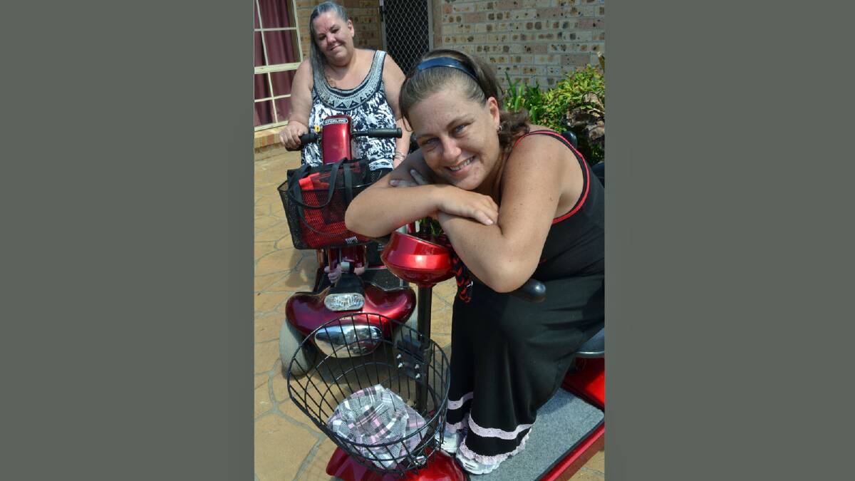 WHEELIE GOOD: Lisa Berry checks out her new pair of wheels, dubbed Little Red, while mum Karon Barford site astride Big Red, her electric mobility scooter.