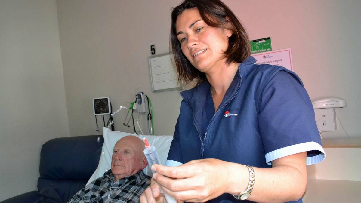 EXTRA CARE: Milton Ulladulla Hospital nurse Emma Vaseo shows hospital auxiliary member Patrick McKenna what would happen inside a renal dialysis unit.