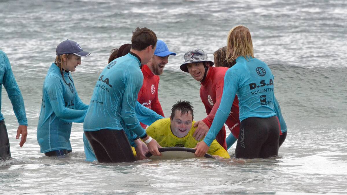 SURFING: Steve Malmo enjoys that water at the Disabled Surfing Day at Mollymook Beach.
